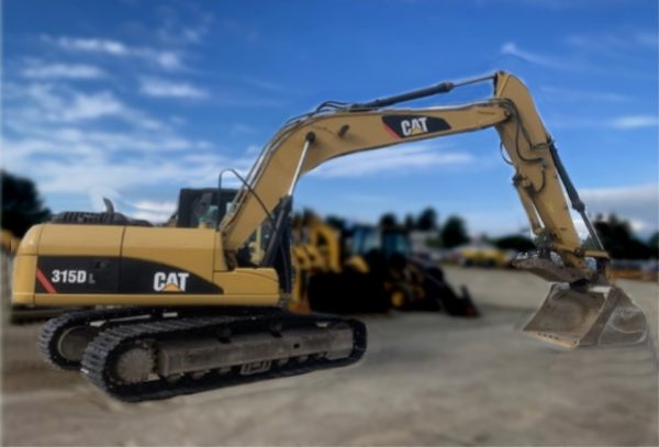 A yellow 2011 CAT 3150 Excavator with a large bucket is parked on a dirt lot, while other construction vehicles appear blurred in the background under a clear blue sky.